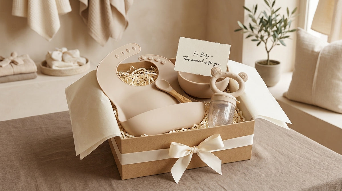 Kraft gift box with a silicone bib, bowl, spoon, teether, and mini glass cup