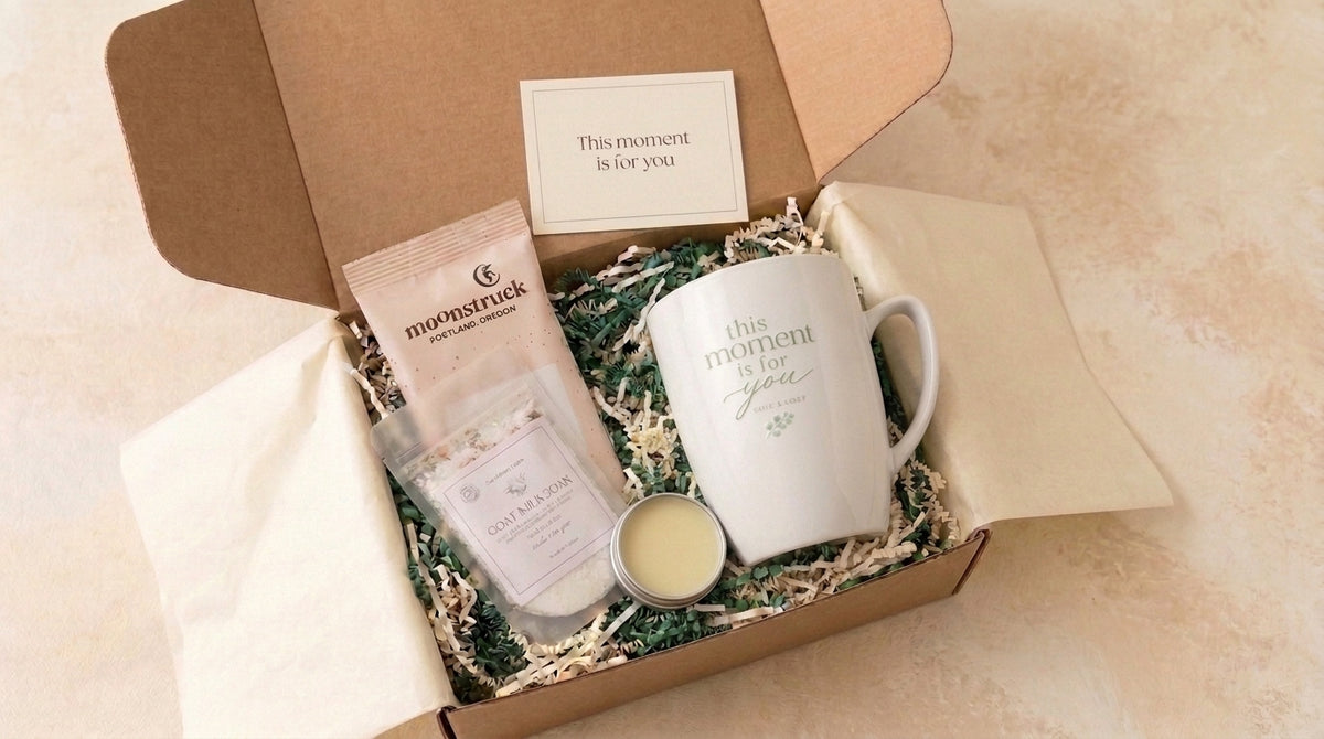Mini spa gift box with a white message mug, goat milk soak pouch, Moonstruck cocoa, open tin and matching message card.