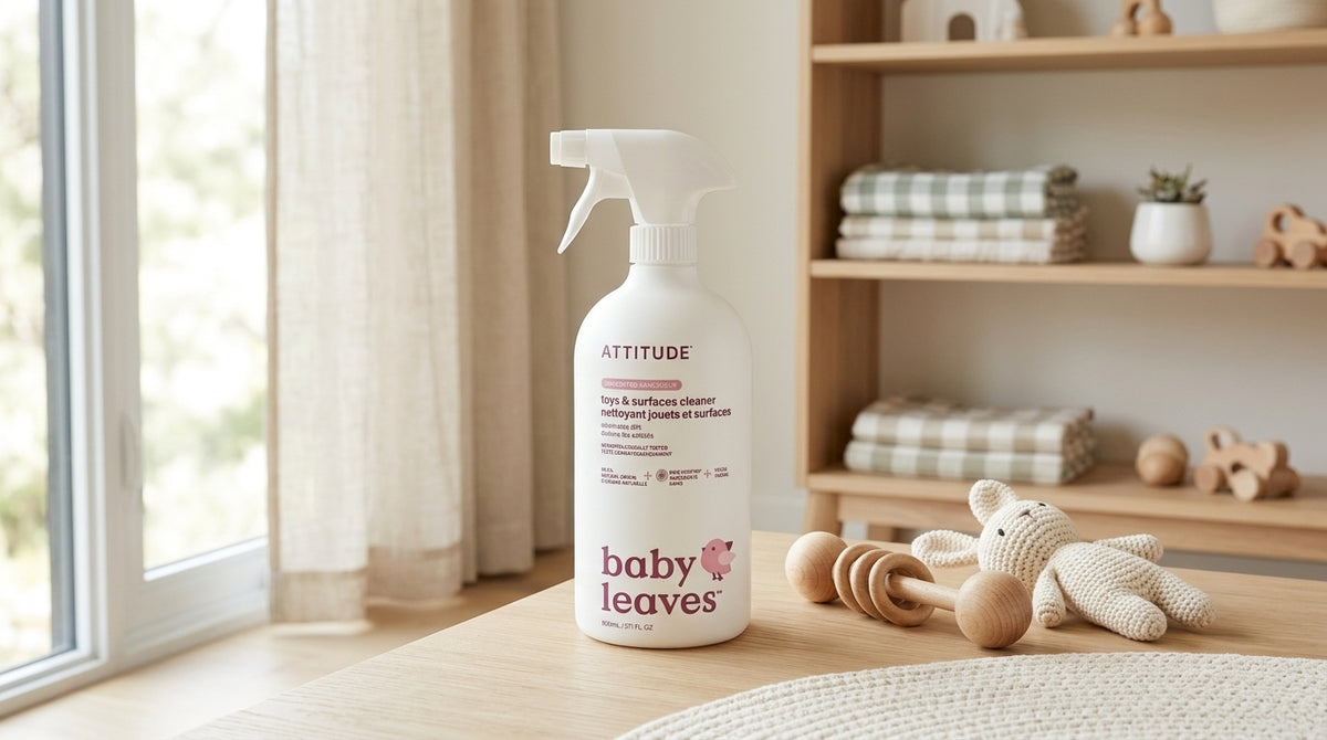 ATTITUDE Baby Leaves toys and surfaces cleaner spray bottle displayed beside wooden and crochet baby toys