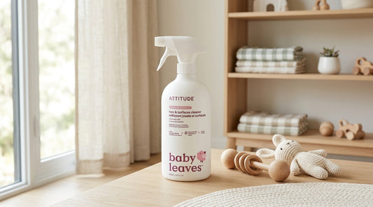 ATTITUDE Baby Leaves toys and surfaces cleaner spray bottle displayed beside wooden and crochet baby toys